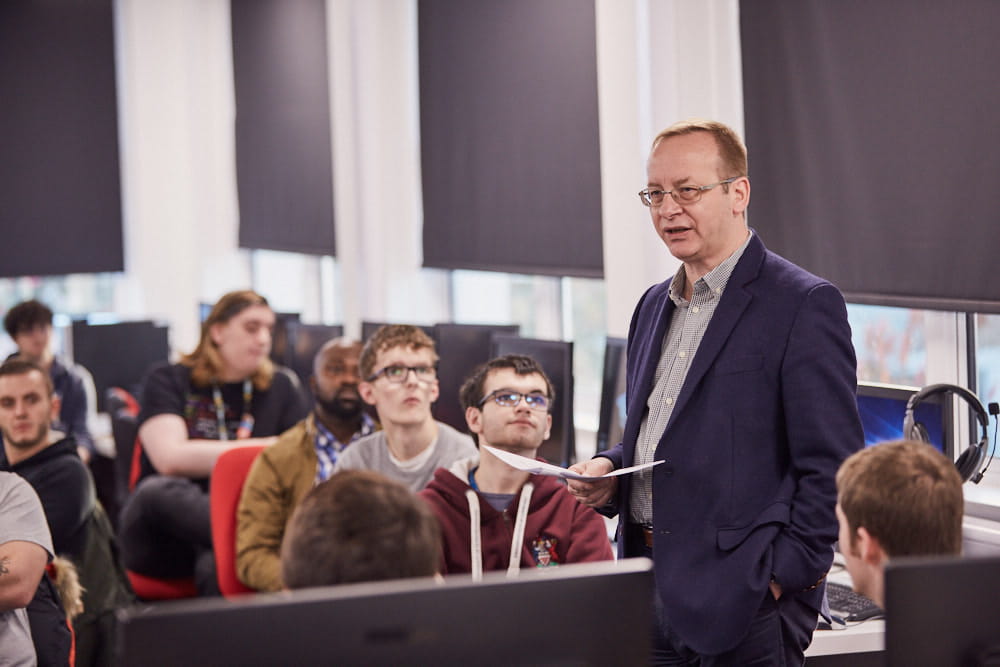 Raytheon executive, Graham LeFevre, provides welcome remarks to the students at University of Gloucestershire.