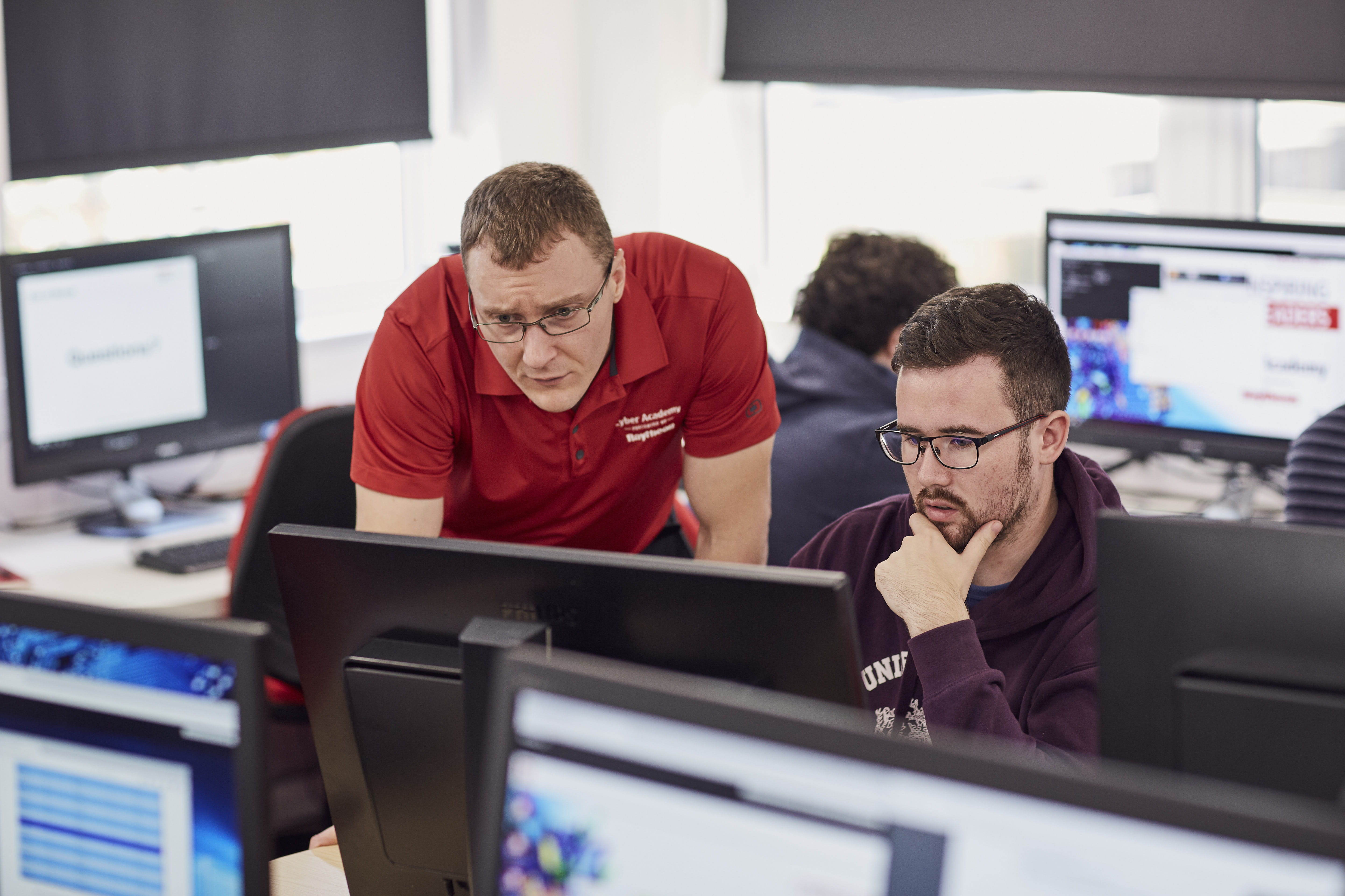 Dr. Keith Harrison, one of the workshop administrators, provides guidance to a University of Gloucestershire student.