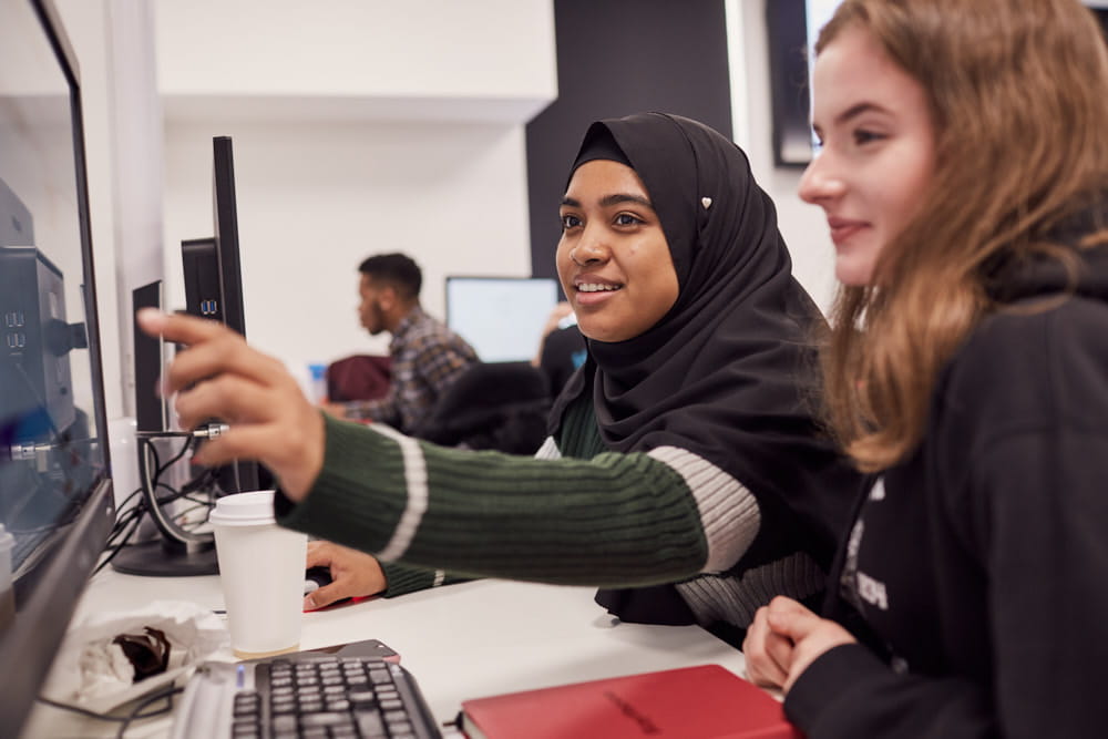 Two students from the University of Gloucestershire step through the cyber training modules during the first workshop.
