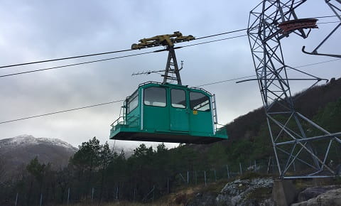 A cable car travelling to the top of the mountain.