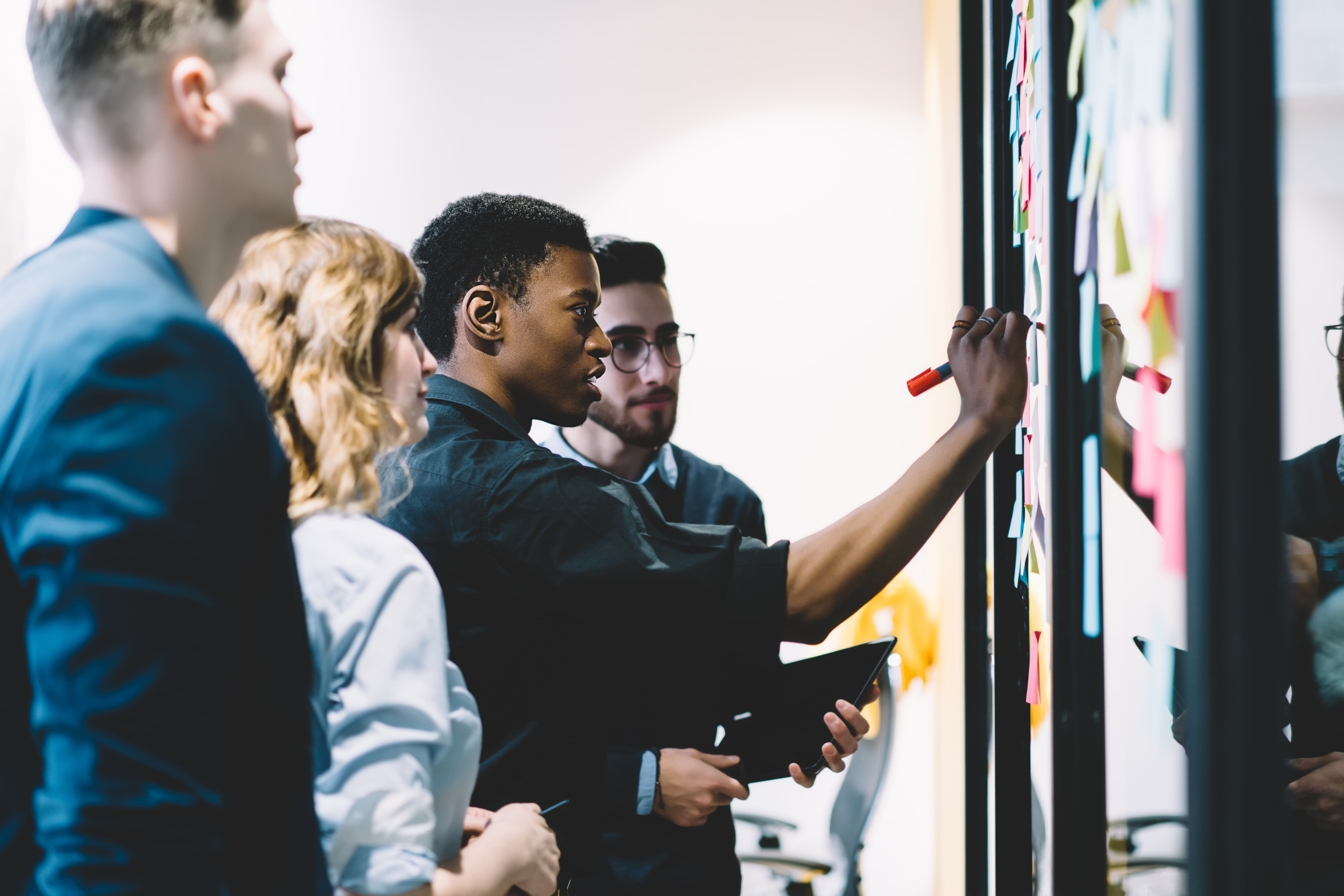 Team members discussing using a board