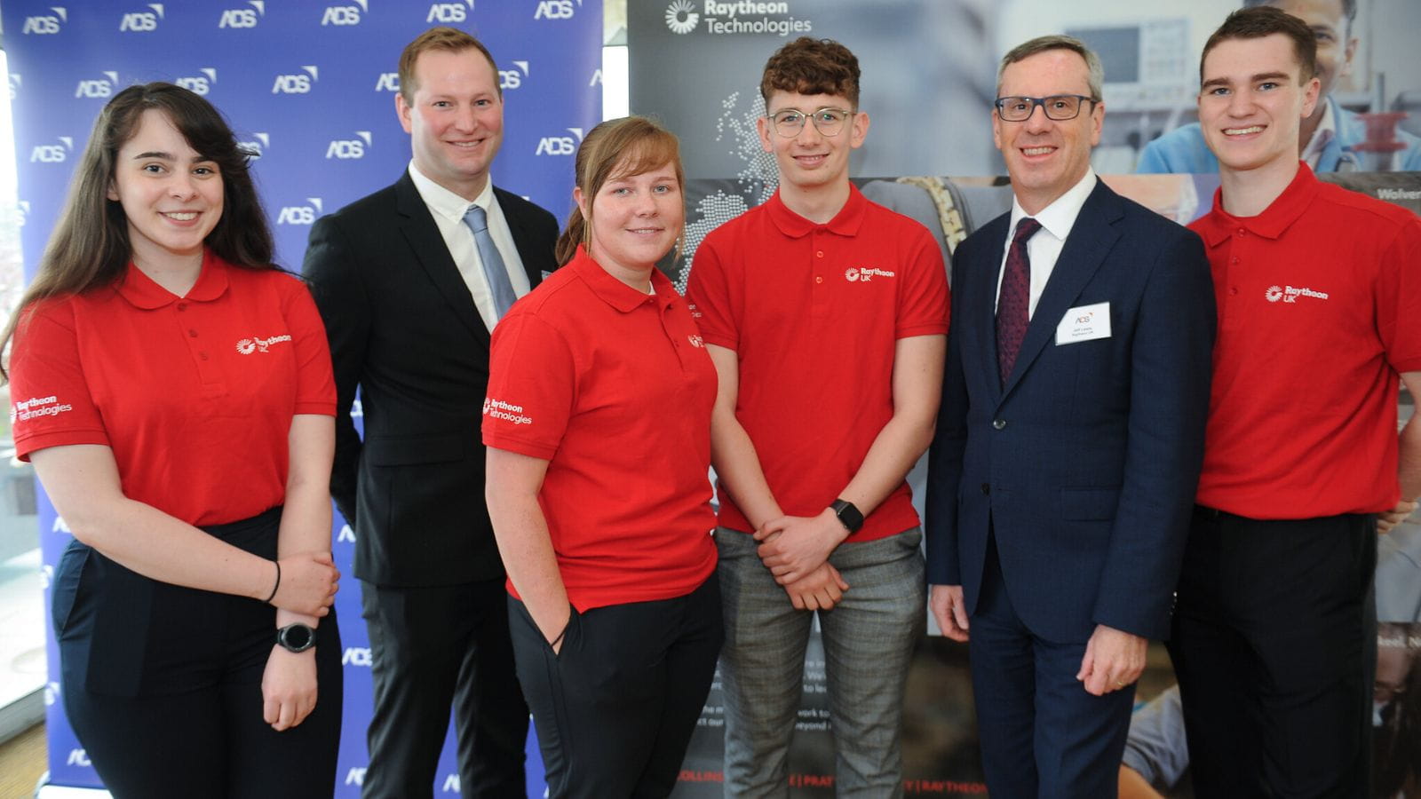 Raytheon UK CEO Jeff Lewis poses for a picture with a group of apprentices