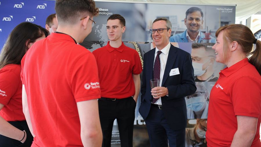 Raytheon UK CEO Jeff Lewis talks with a group of apprentices