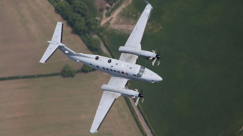 Aircraft in flight over rural setting