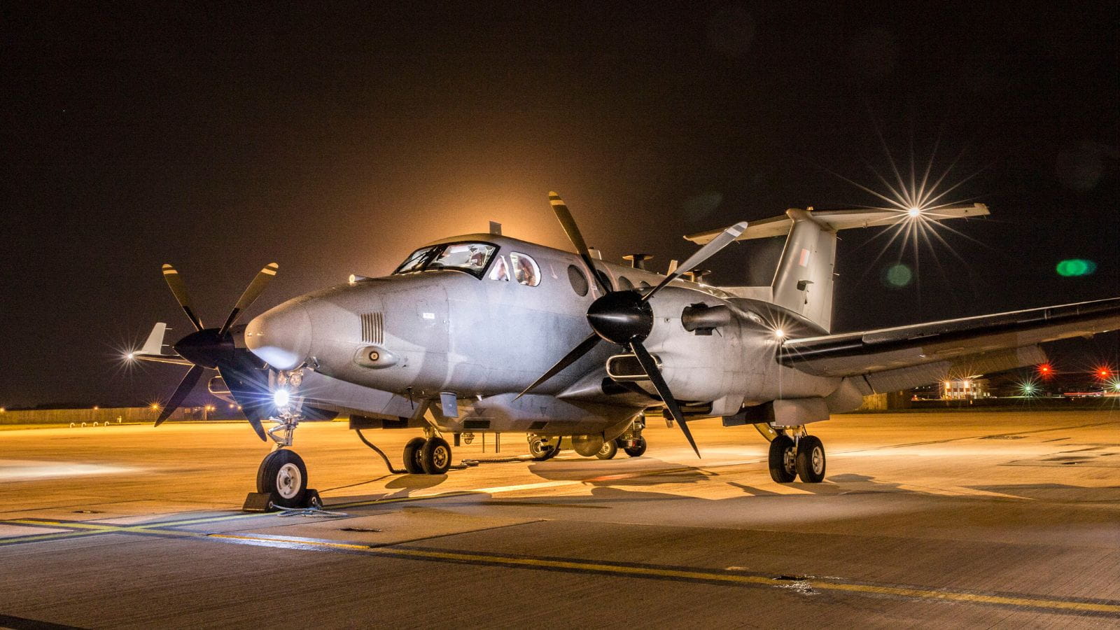 An RAF aircraft stationary on the runway at night