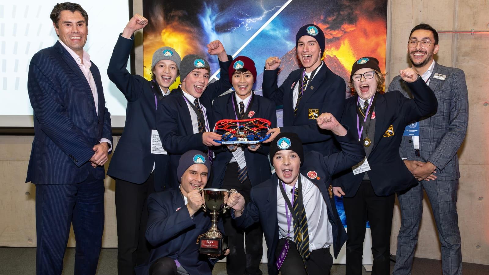 Team Glacial Flyers hold their quadcopter and their winning trophy