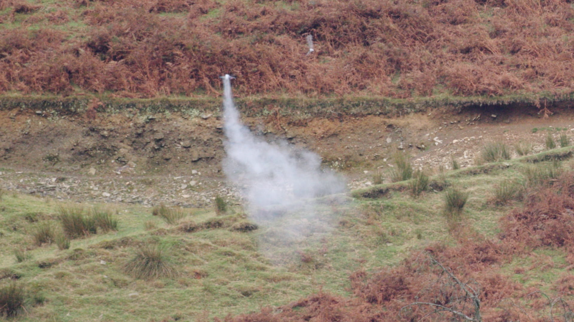 A drone with a tail of smoke after being shot down