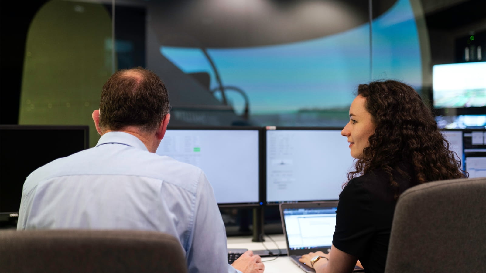 Engineers controlling a flight simulator