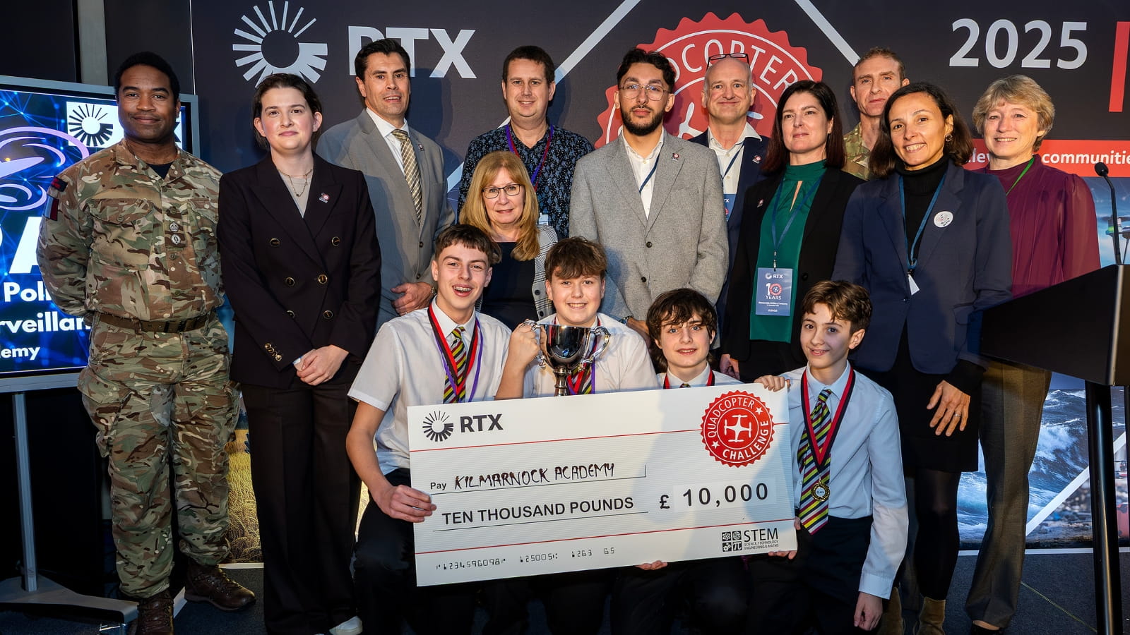 The winning team, their teachers, judges, STEM ambassadors and British Army representatives on stage