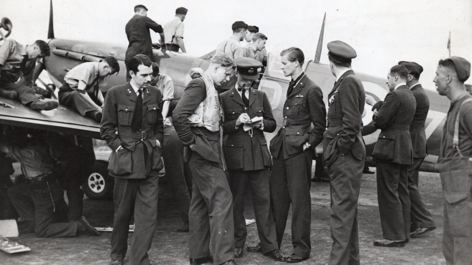 Battle of Britain: Ground crew turnaround a Spitfire while Flight Lieutenant John Bisdee is debriefed by an intelligence officer (copyright: Chris Goss)