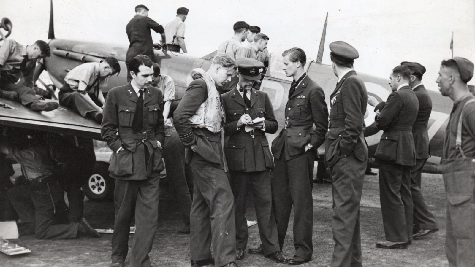 Battle of Britain: Ground crew turnaround a Spitfire while Flight Lieutenant John Bisdee is debriefed by an intelligence officer  (copyright: Chris Goss)