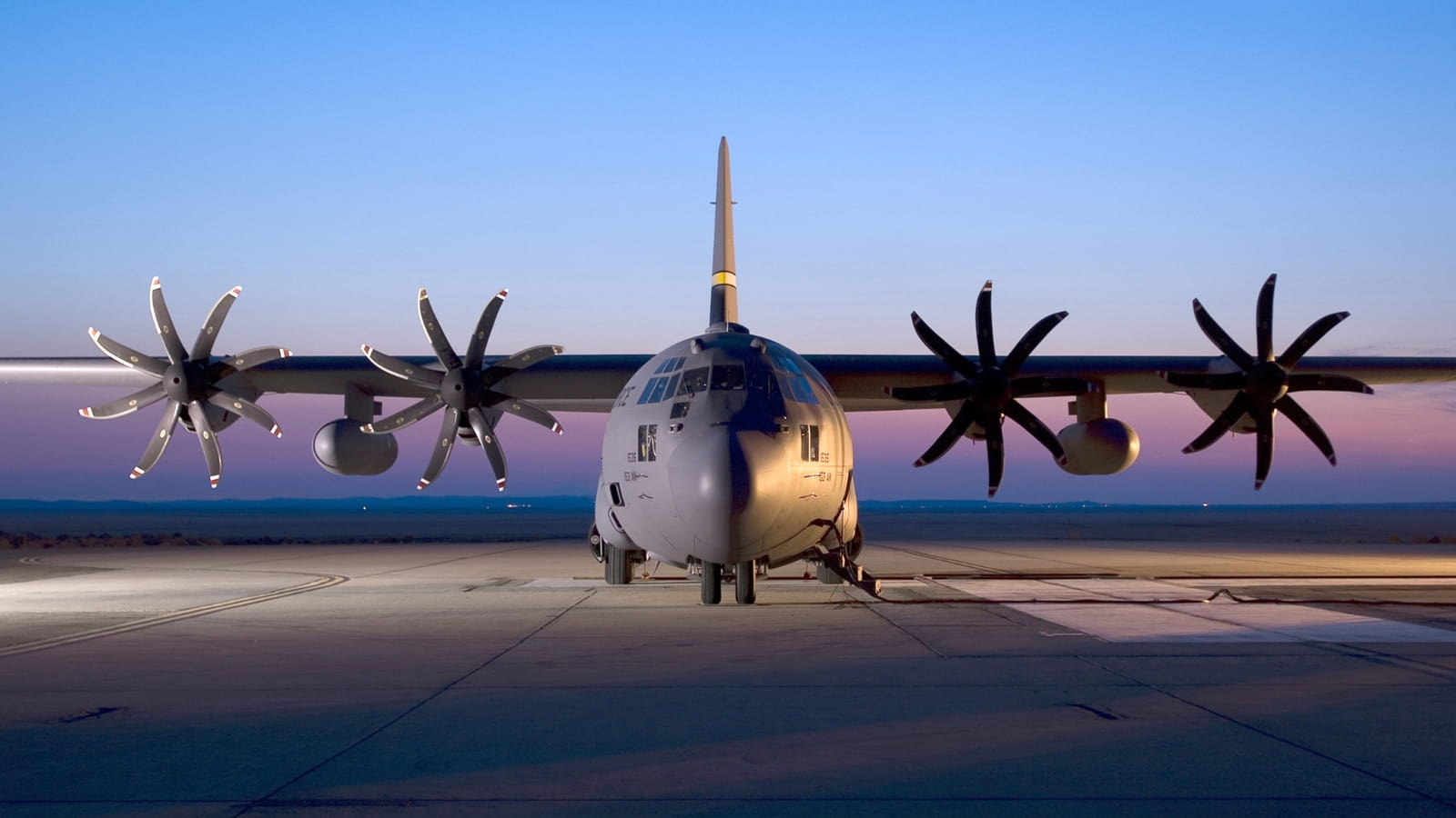 A propeller plane against a sunset