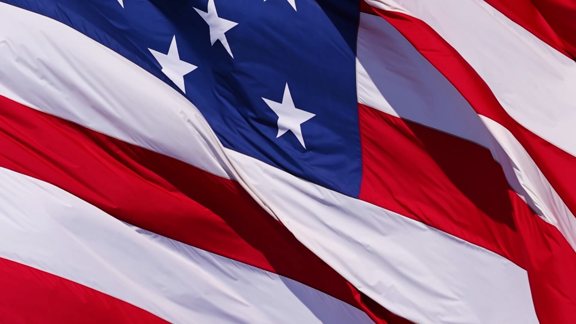 Close-up picture of the United States flag. Stars and stripes are visible.