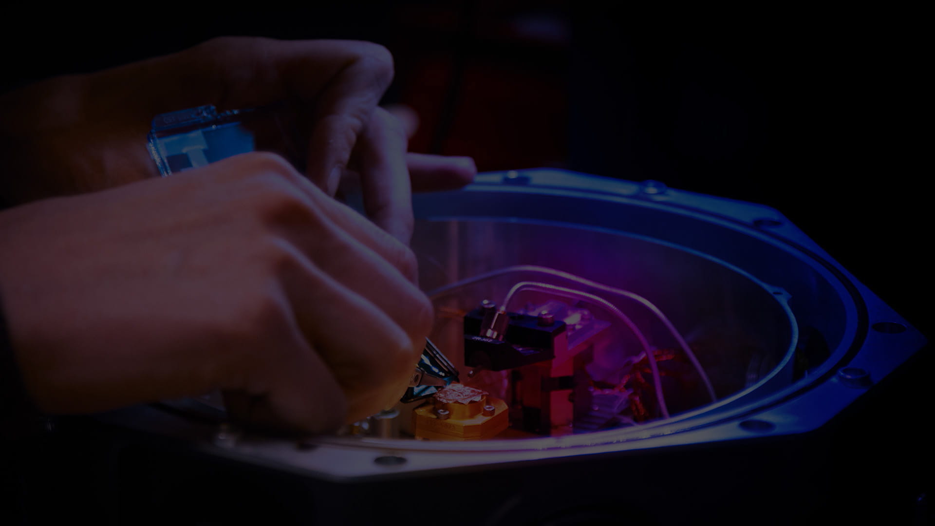 Close-up of hands working on electronic components
