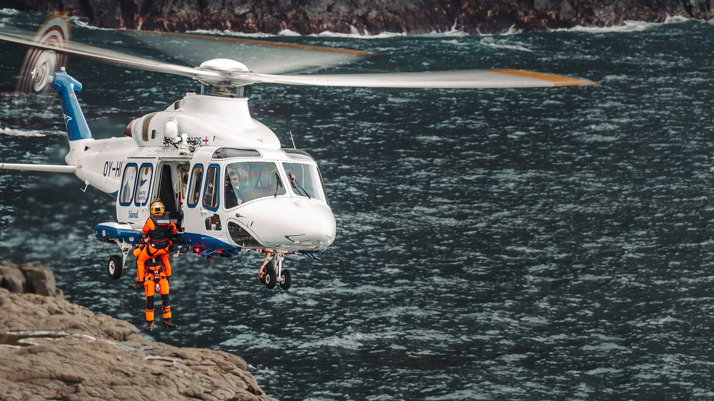 Civil aviation AW139 helicopter hovering over water