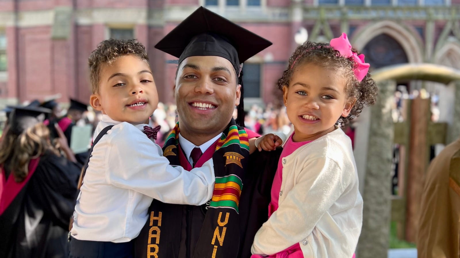 father with daughters at his graduation ceremony