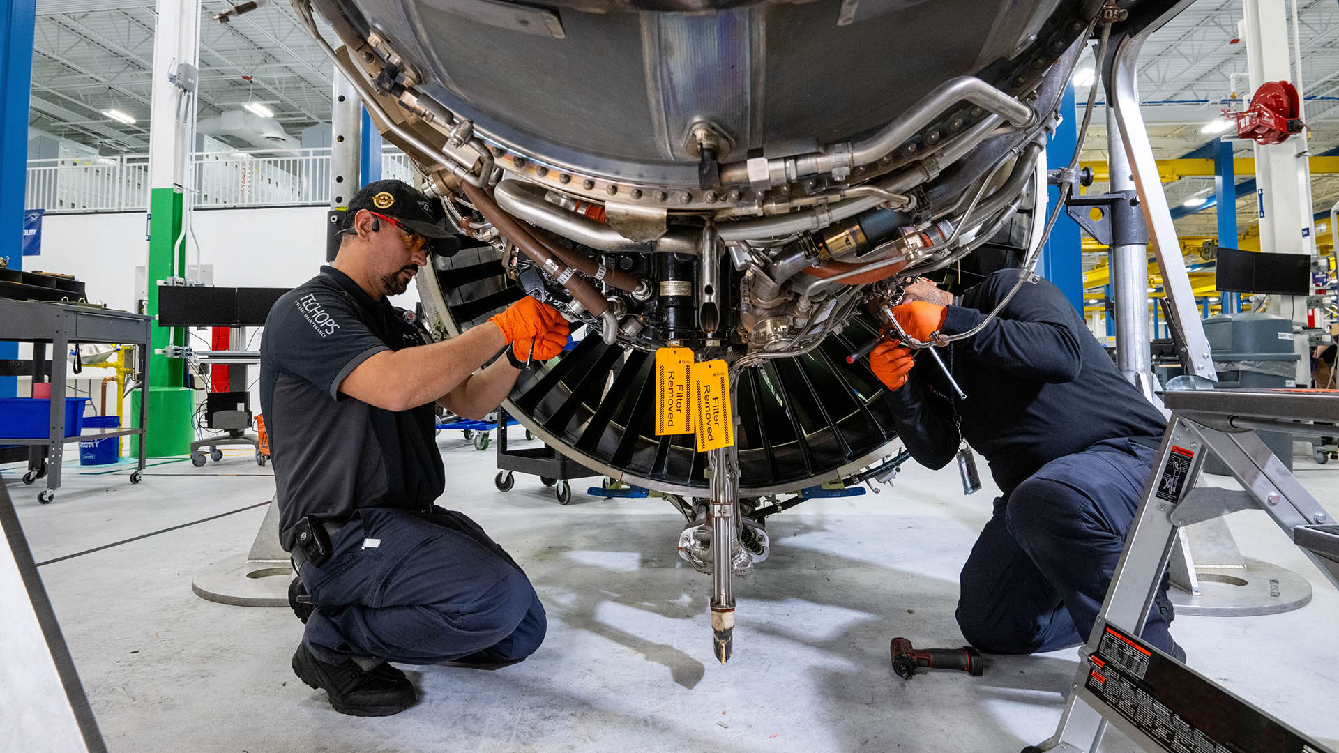 aircraft engine maintenance being performed by two technicians