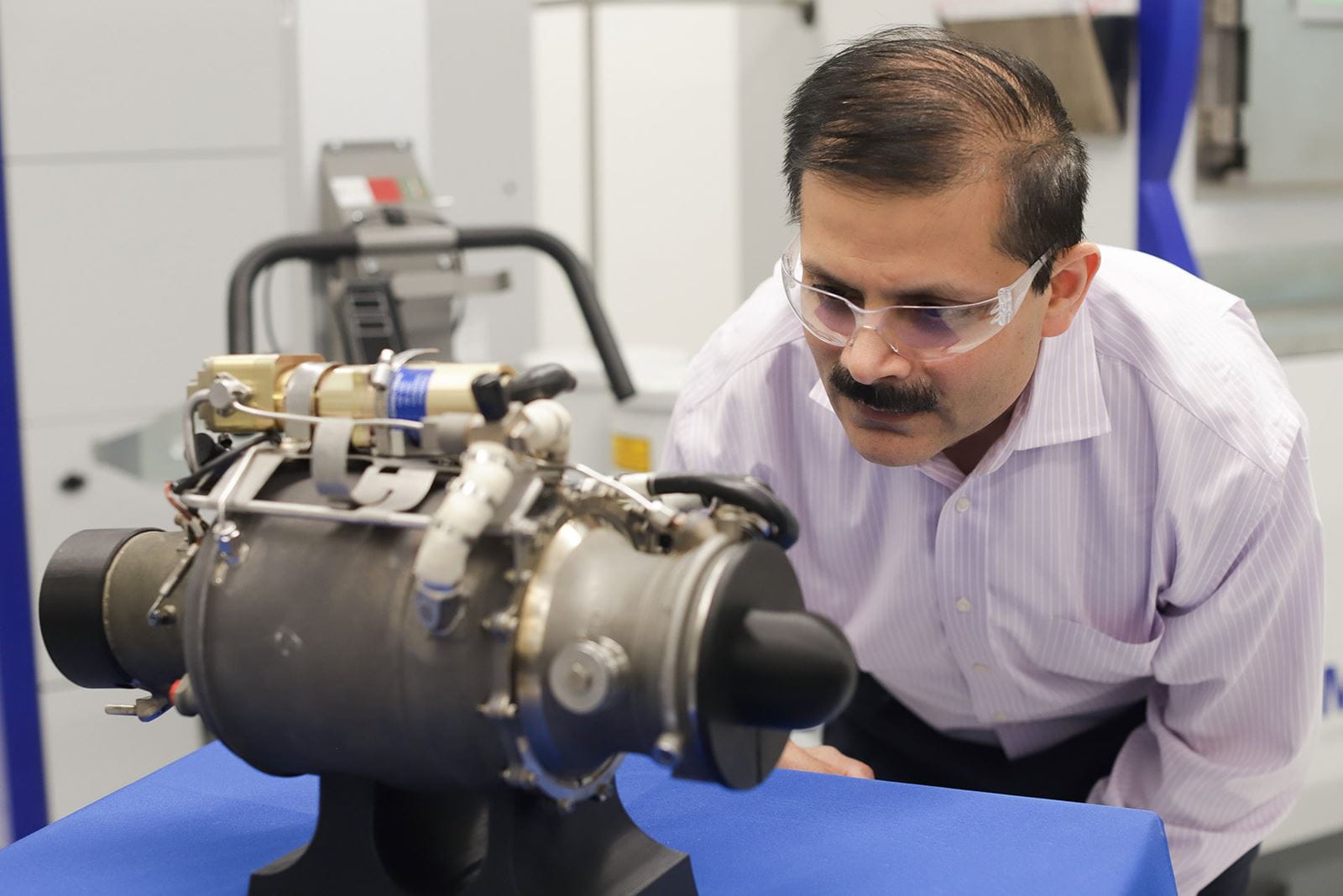 Venkat Vedula, executive director of the Raytheon Technologies Additive PCC, with a small turbojet engine with a 3D-printed main body.