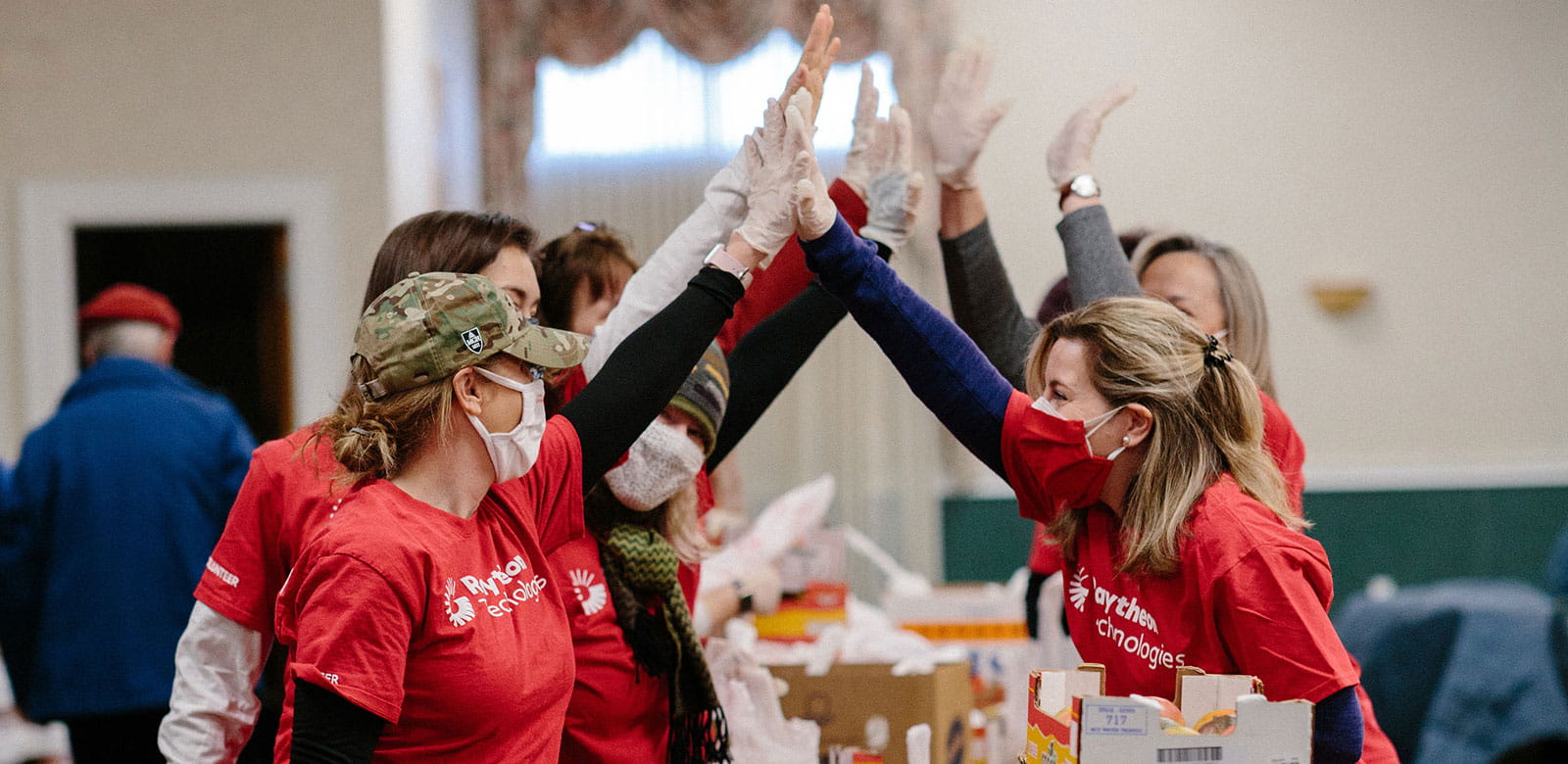 Raytheon Technologies employees giving high-fives