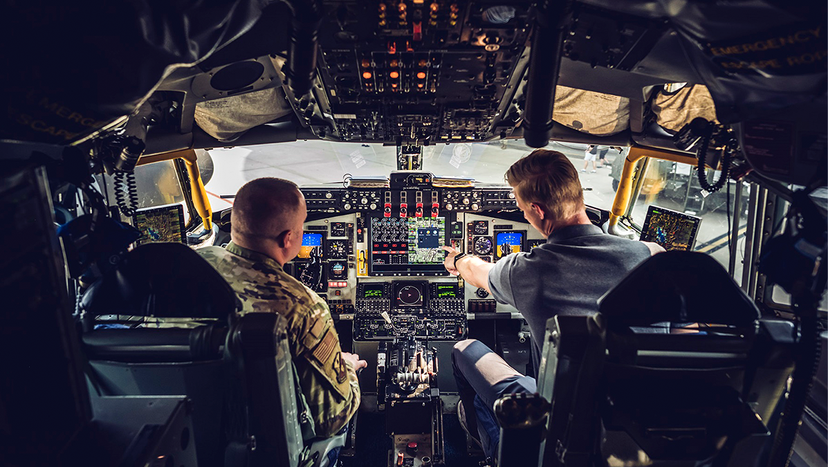 Pilot and co-pilot managing aircraft controls in a cockpit