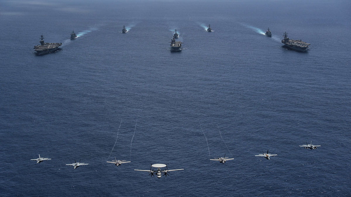 photo of an aerial view of navy ships in formation