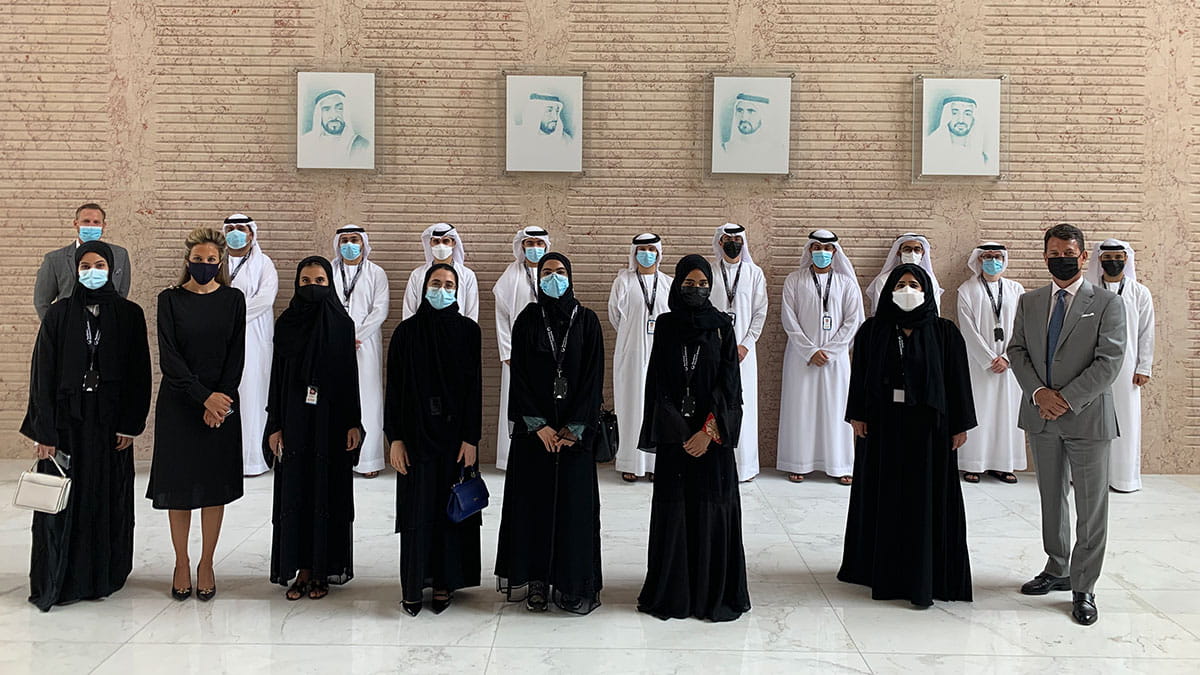 Arab women standing in a line in front of a line of Arab men