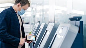 Man getting ticket for plan using mobile device.