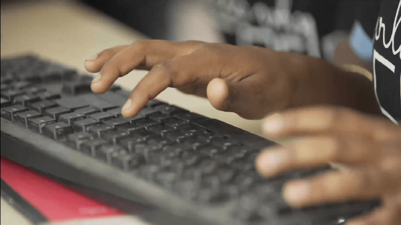 a person typing on a keyboard