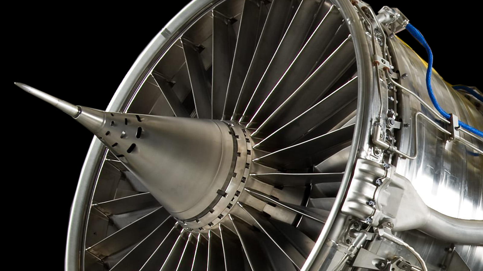 A close-up showing the fan blades of a military jet engine.