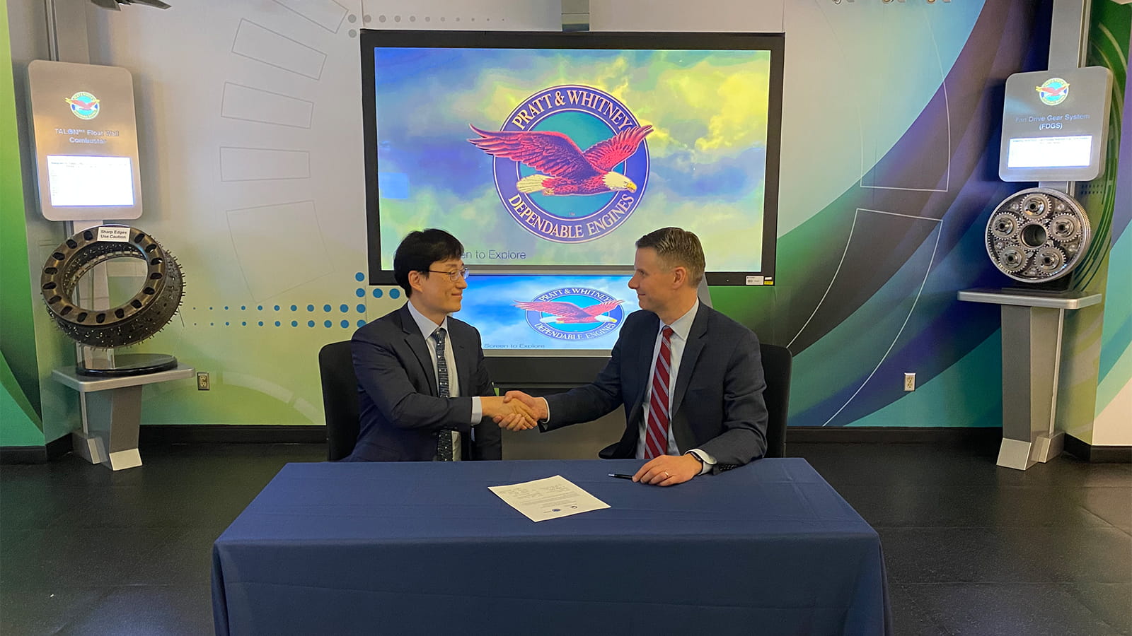 “Chris Johnson, vice president of Fighter and Mobility Programs at Pratt & Whitney (right), and Director General Lee Gui-Hyun (left) sign the third consecutive performance-based logistics contract that Pratt & Whitney and DAPA have signed since 2012, offering on-going maintenance support for the Republic of Korea Air Force’s F-15 Eagles and F-16 Fighting Falcons.”