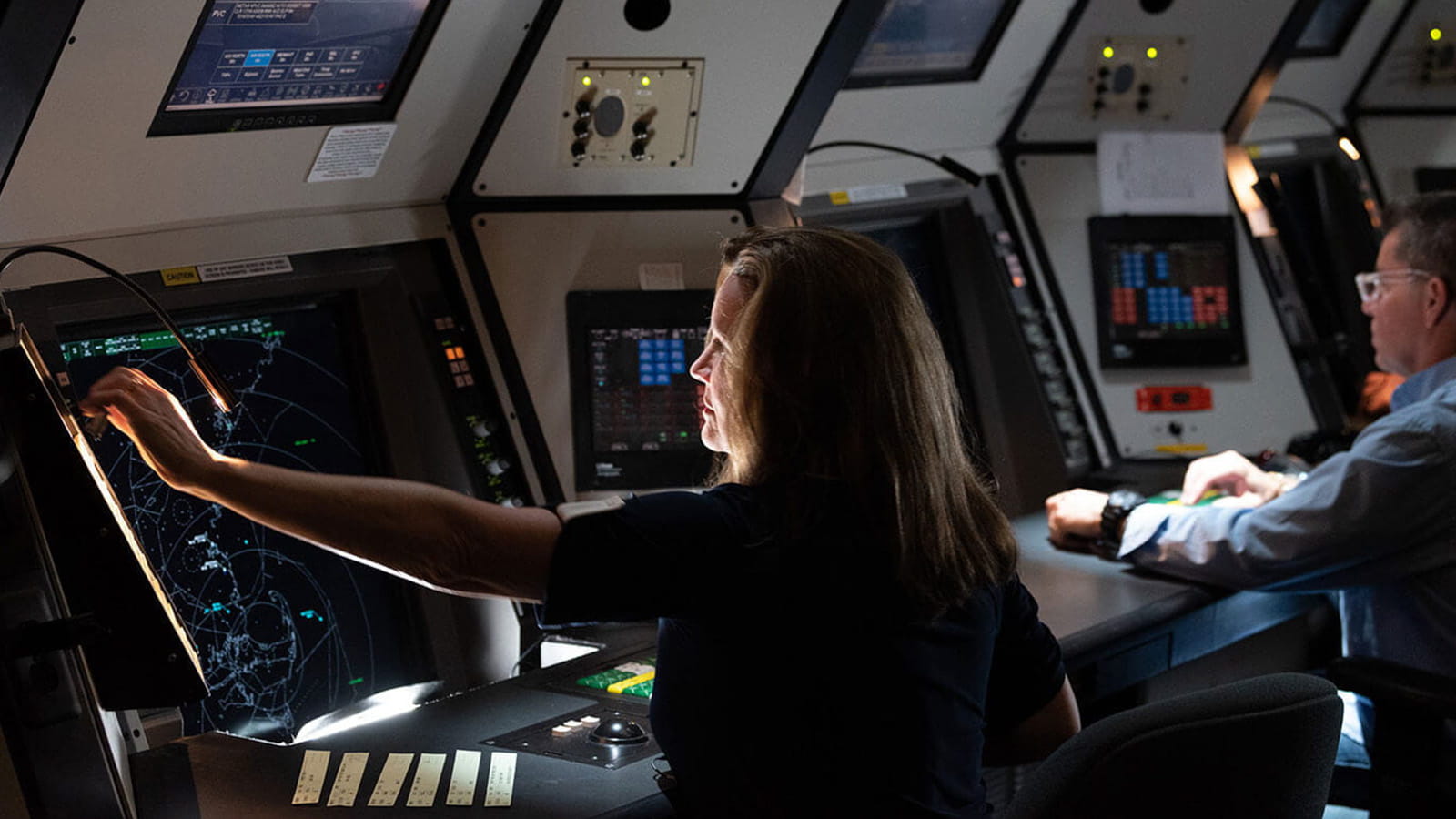 STARS terminal in use, employee reaching for screen