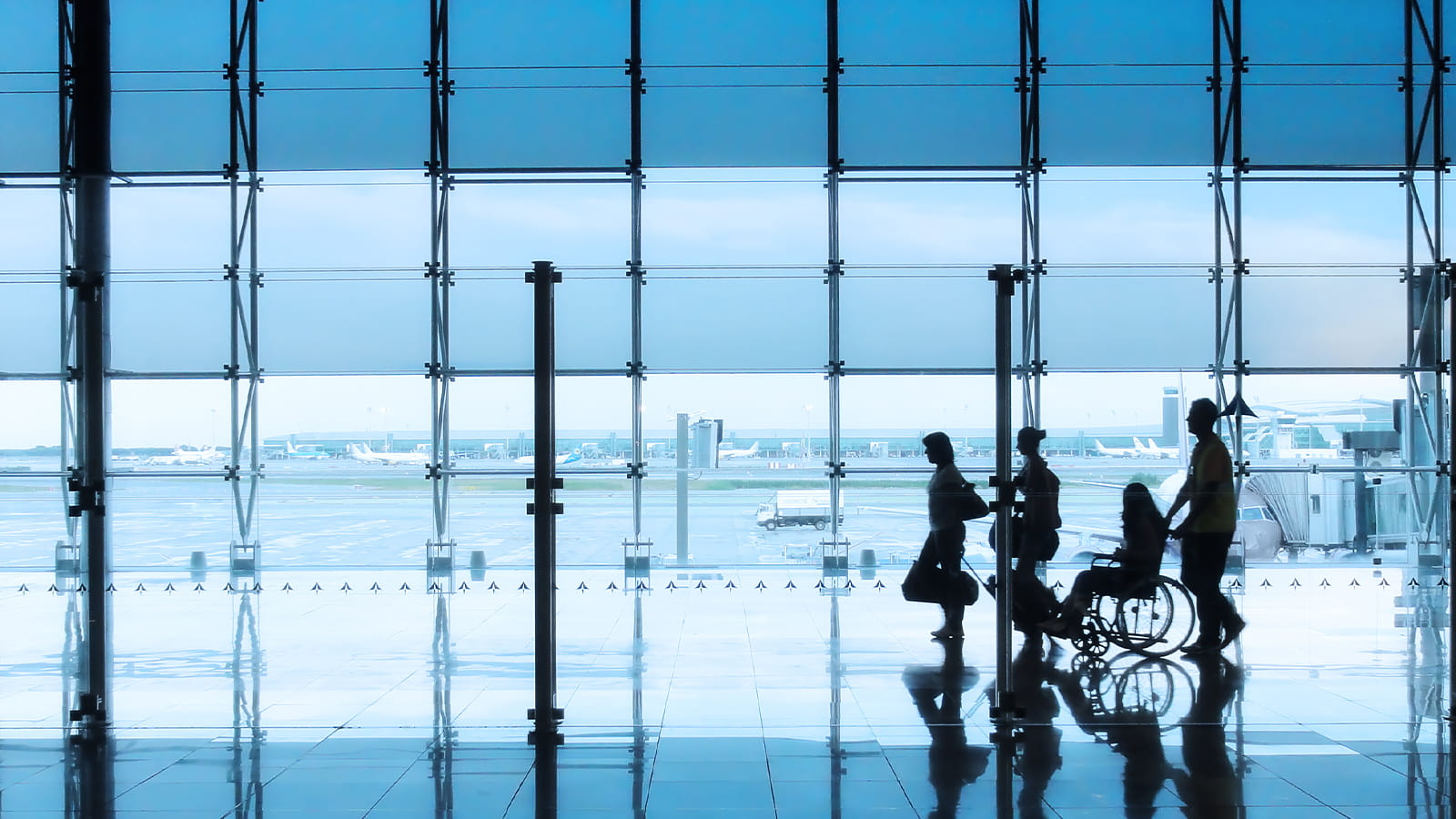 a group and one person in a wheelchair at the airport