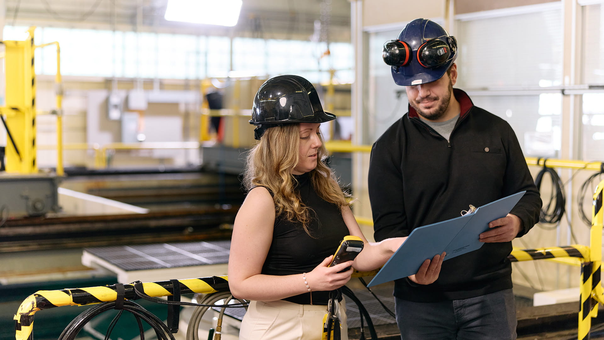 Workers examining document - factory floor