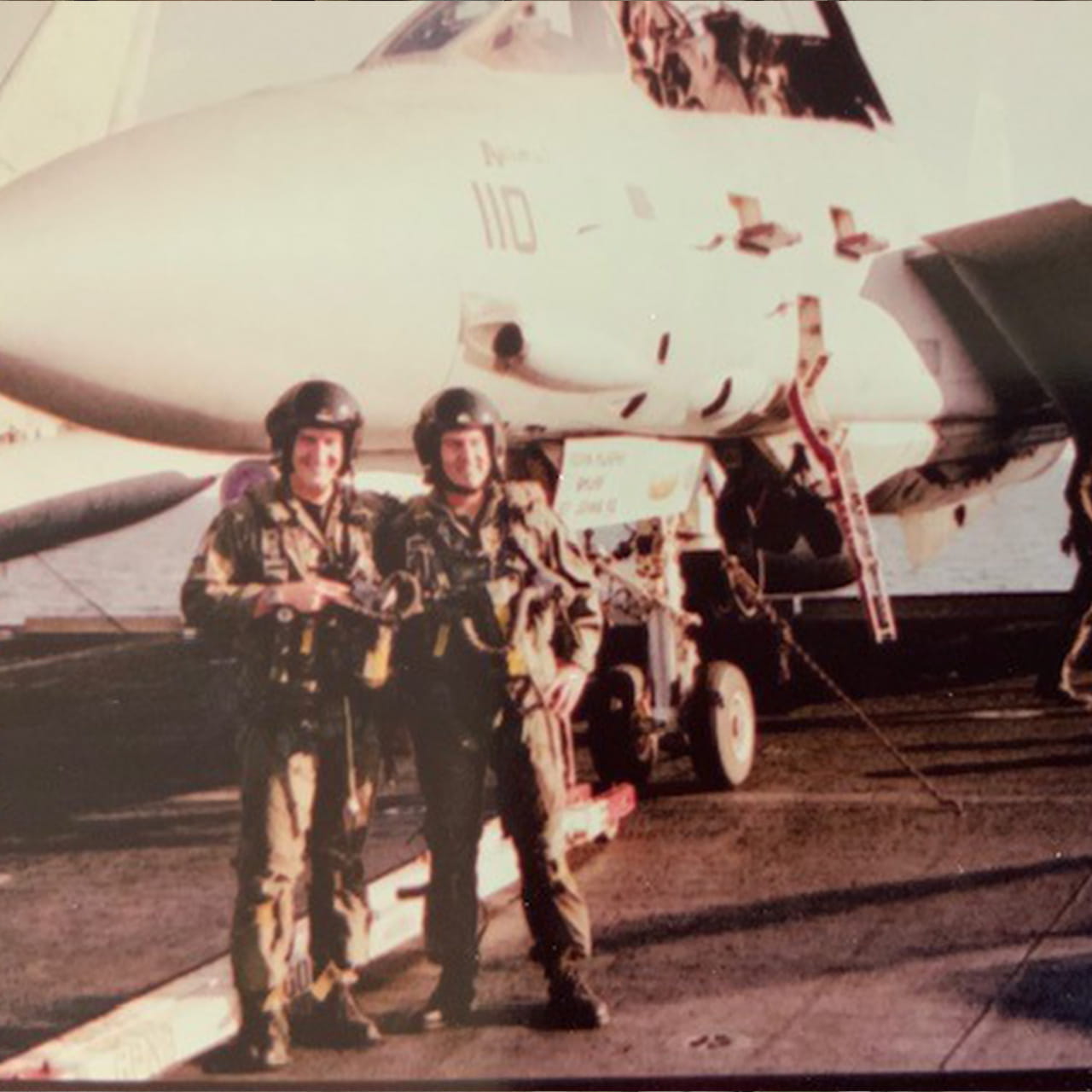 Rick and his father in front of an F14A on an aircraft carrier