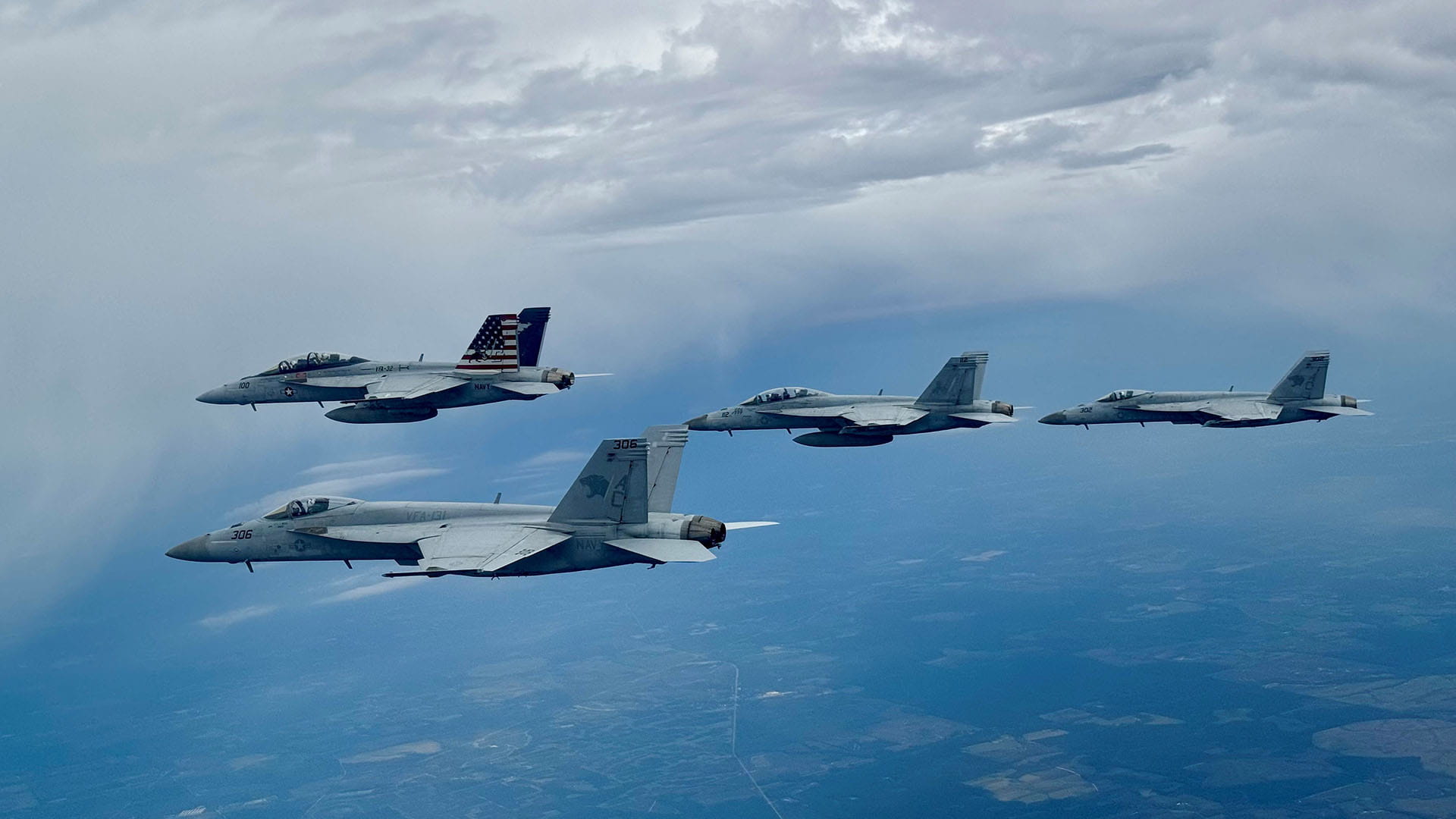 four jet fighters in flight