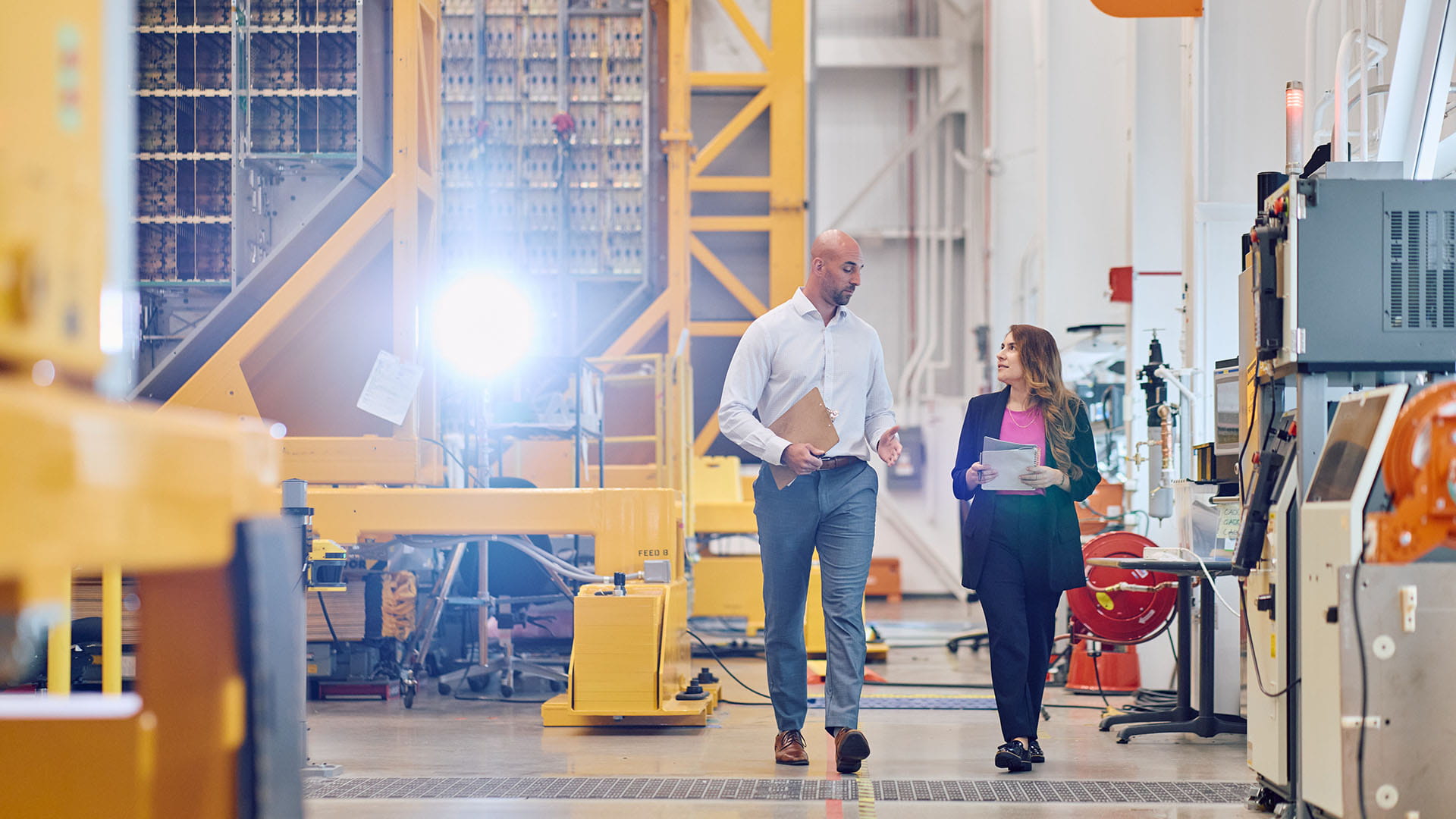 Two employees walking together inside the facility