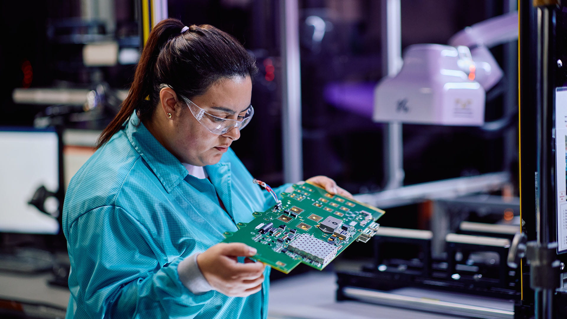 an operator inspecting a circuit board
