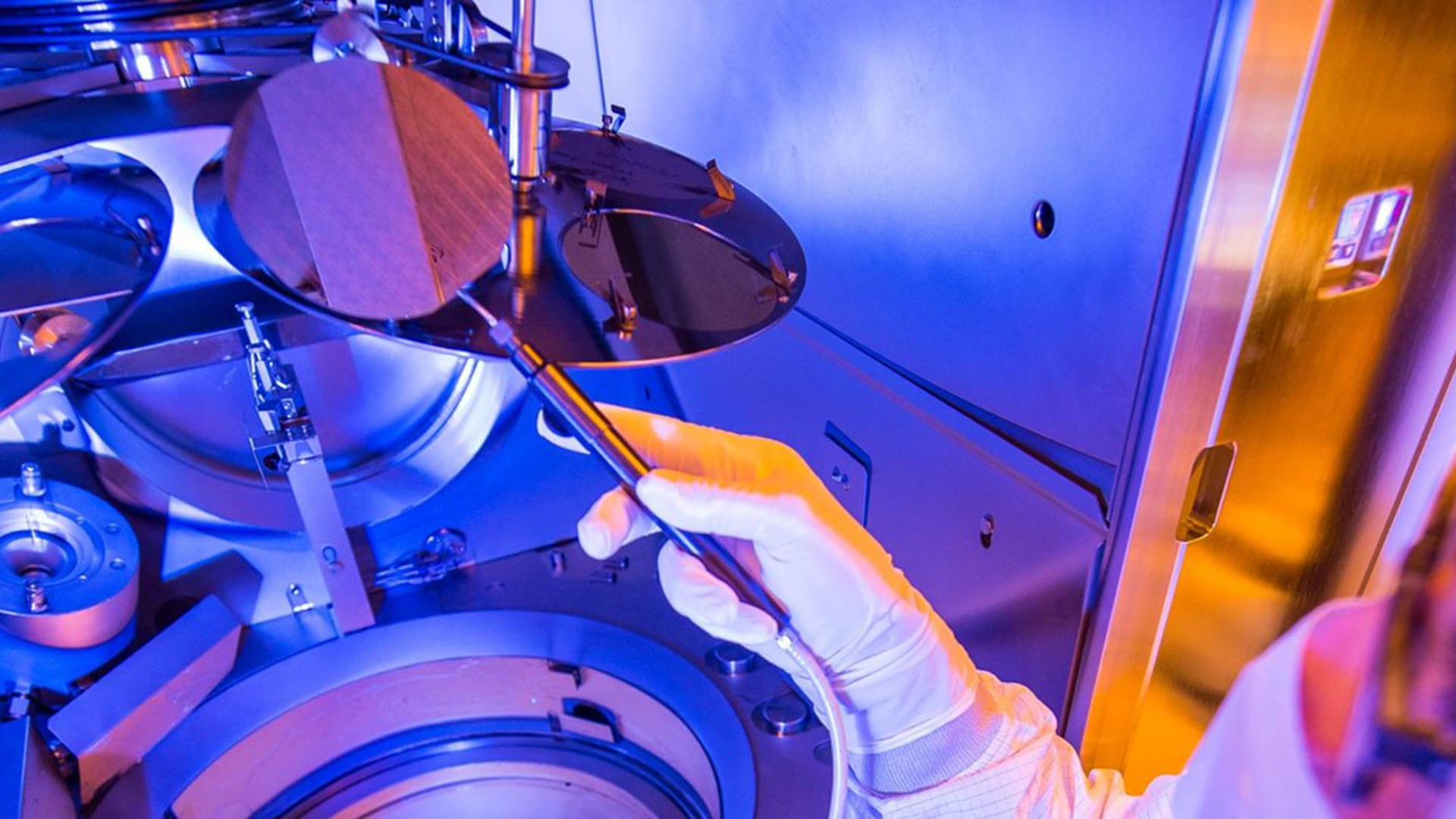  A technician in the process of assissting in the manufacturing high-quality wafers