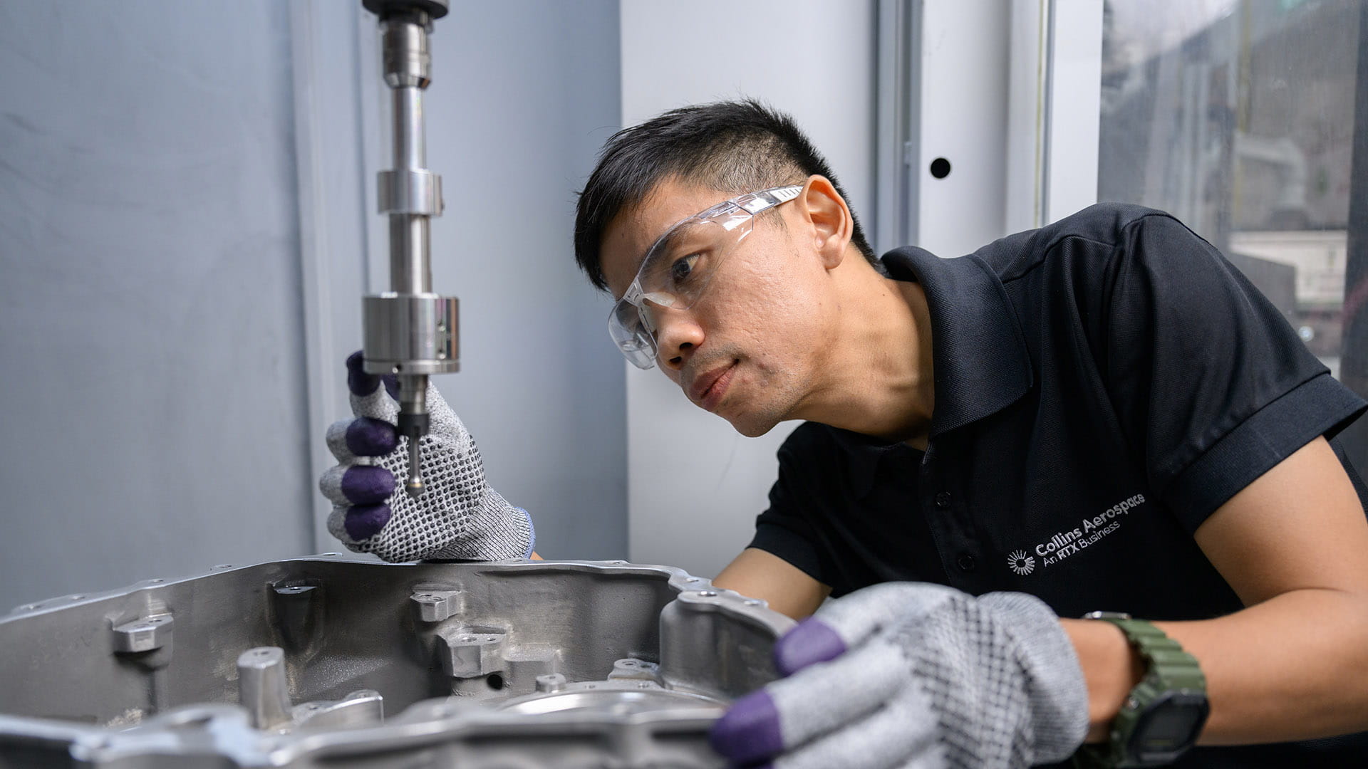 a technician working on a part.