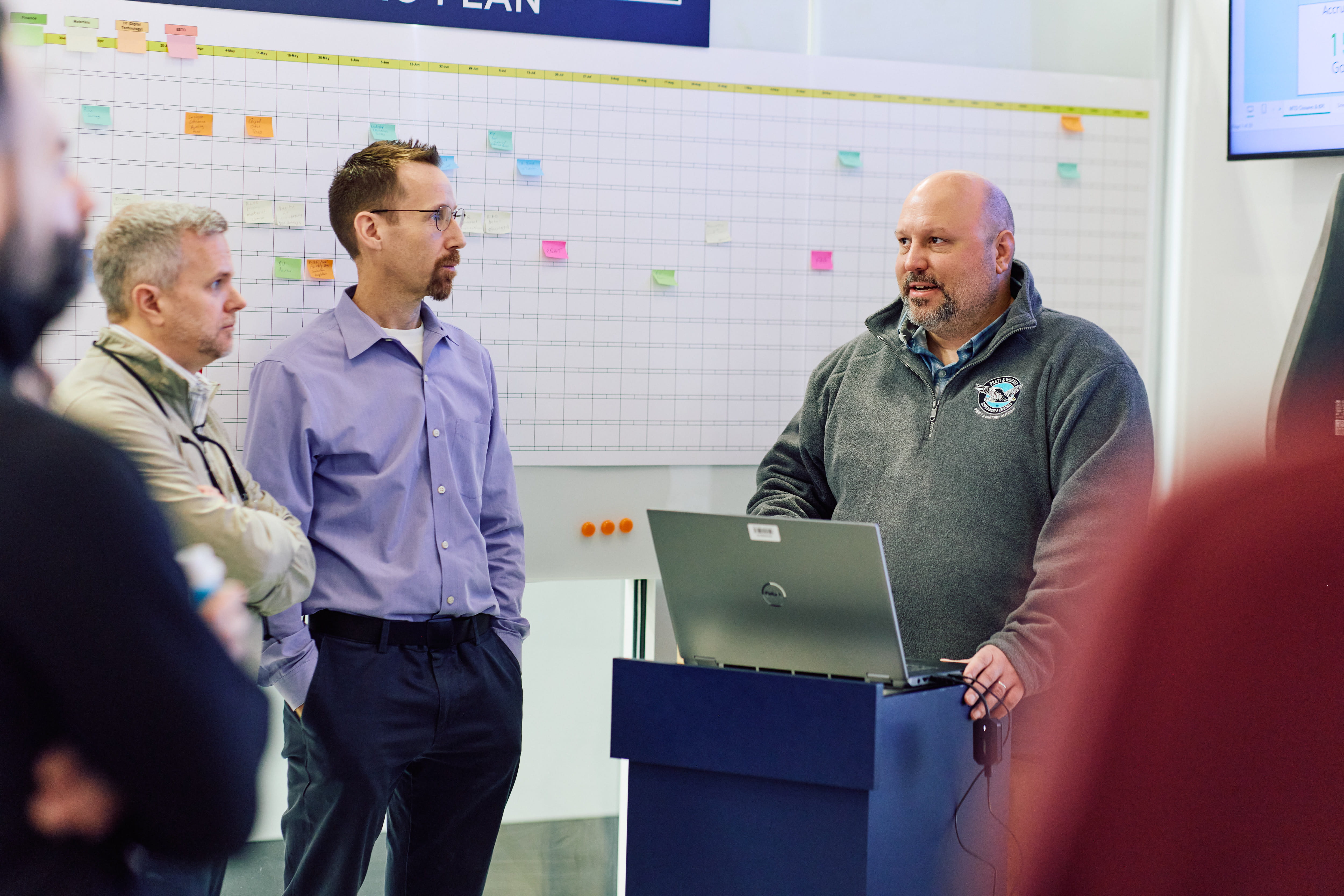 employees attend a CORE control room stand-up meeting