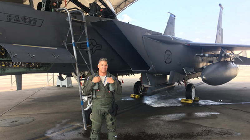 Pilot in front of aircraft in hangar