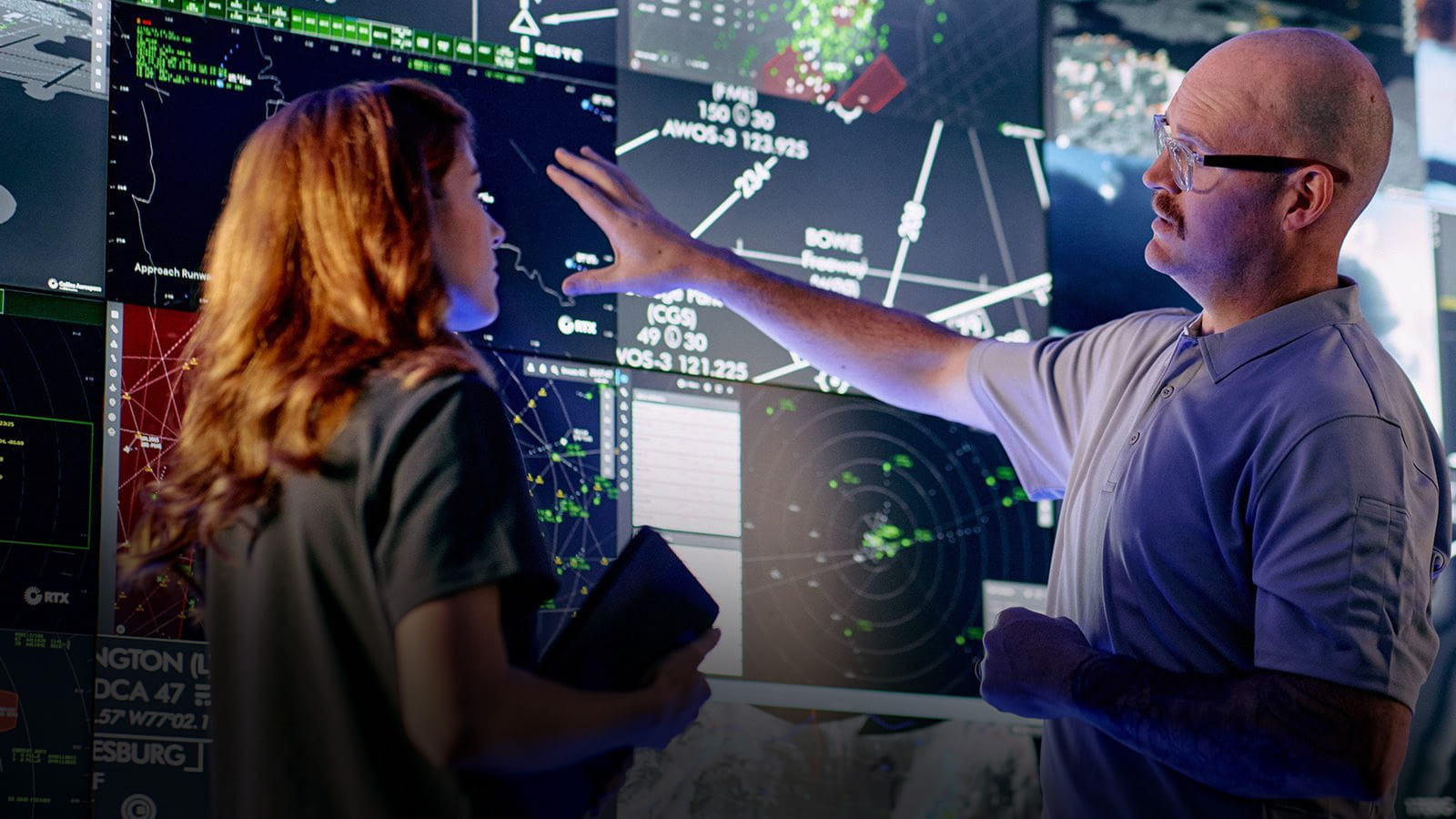 Controllers interact with advanced airspace surveillance and automation displays at a Collins Aerospace facility