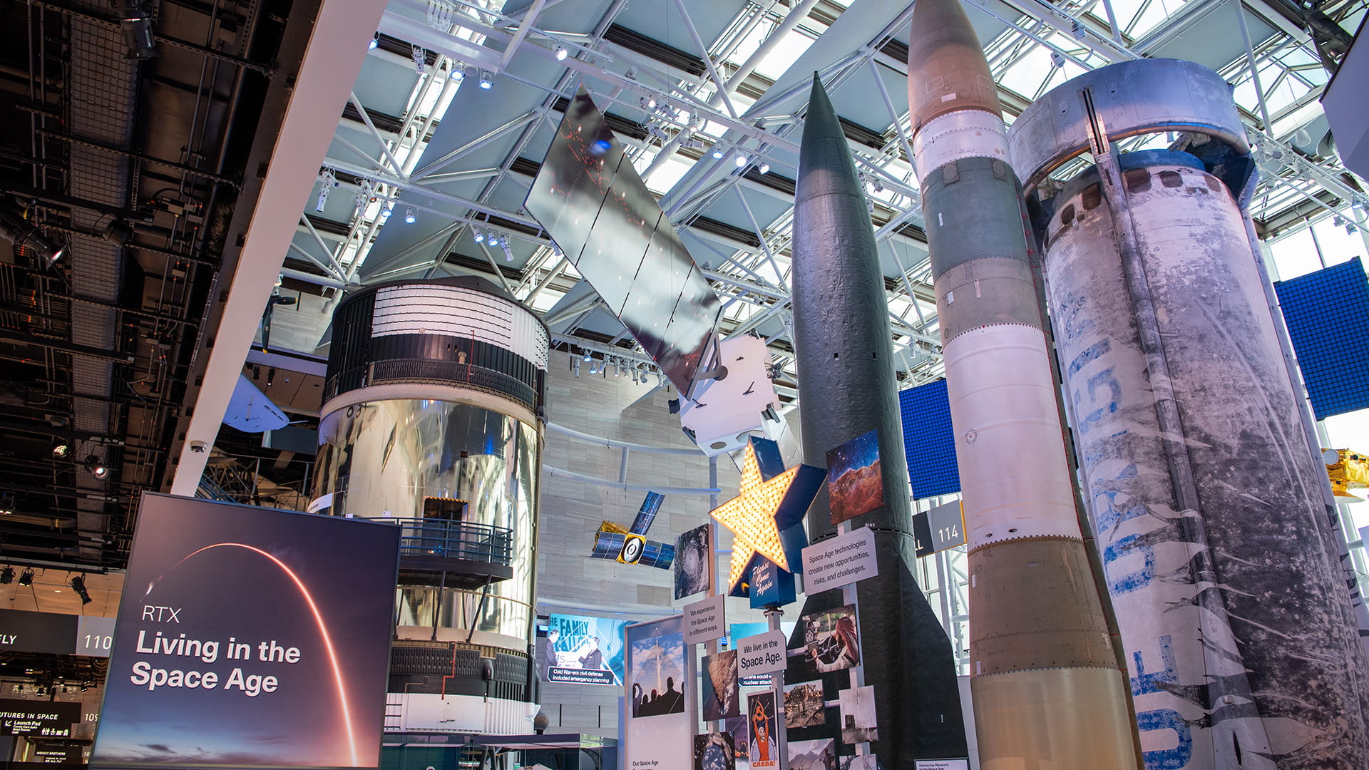 RTX space exhibit showing rockets and satellites