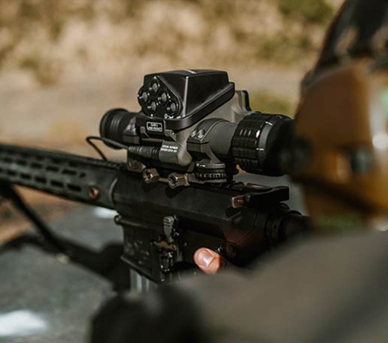 Image focused on the optics attached to a military weapon