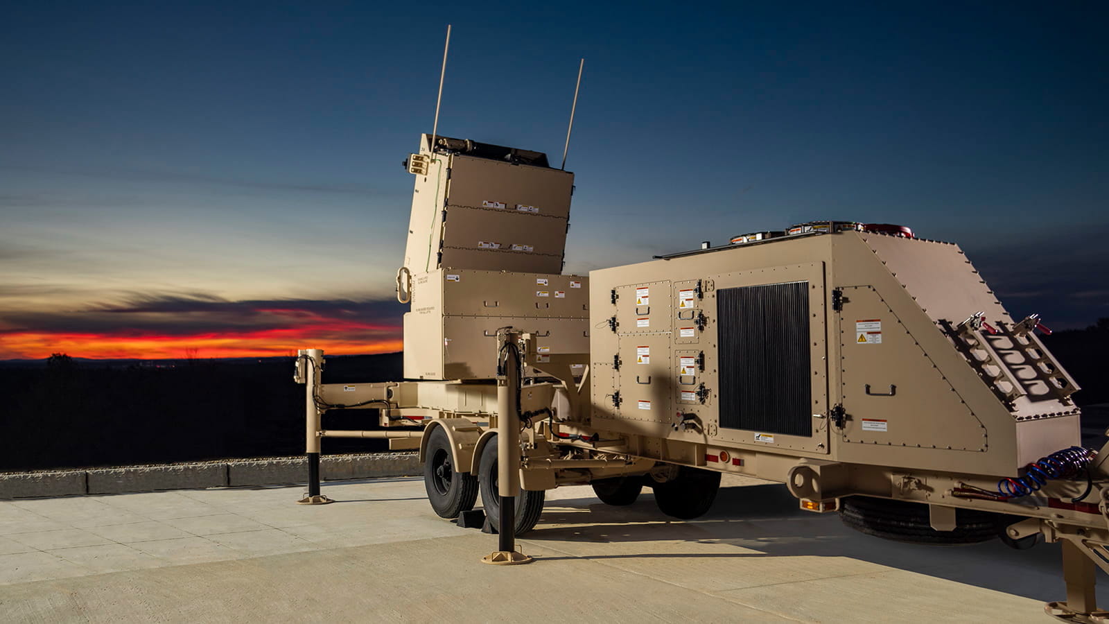 A military missile defense radar with a sunset in the background