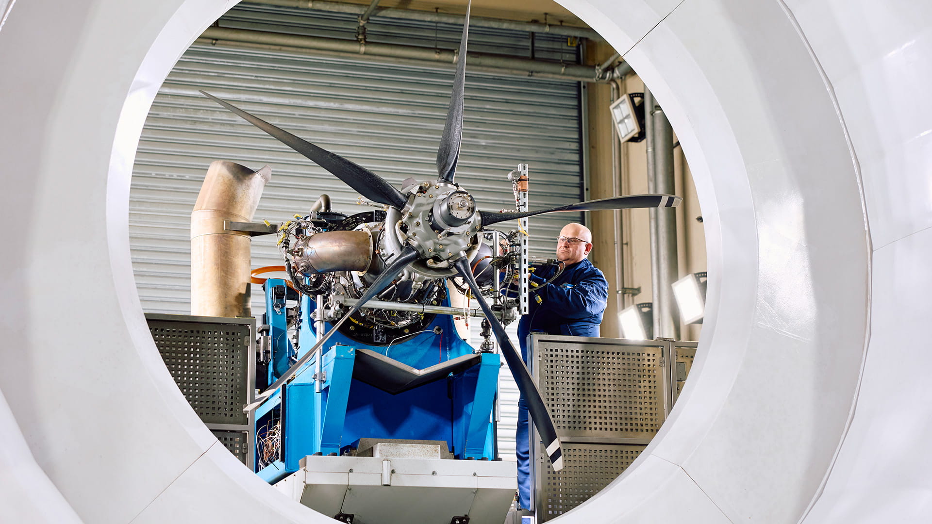 1 employee examining an engine