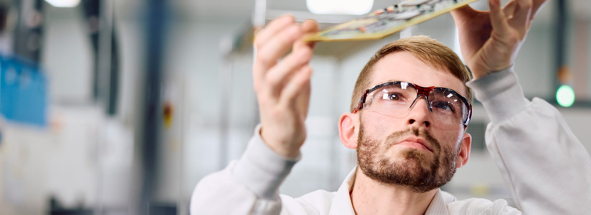 Employee inspecting circuit board