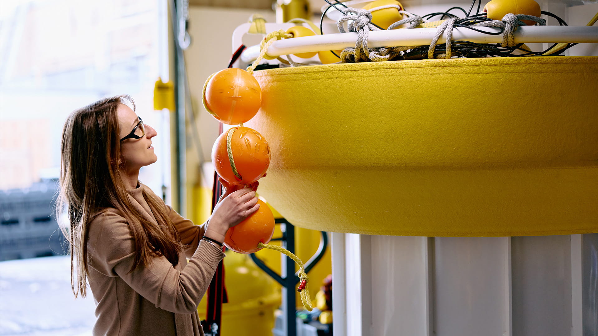 Portsmouth employee working with small buoy