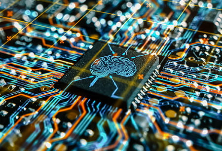 Computer board circuits connected to a chip with a brain engraved on it