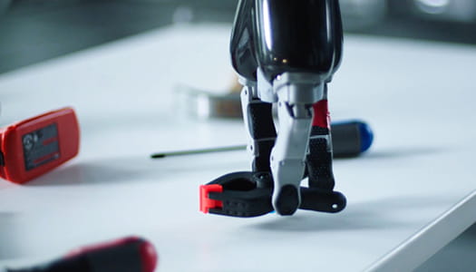 This is a photo if a robotic hand lifting a spring clamp.